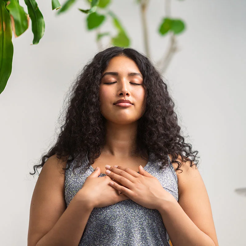 Woman closing her eyes and meditating